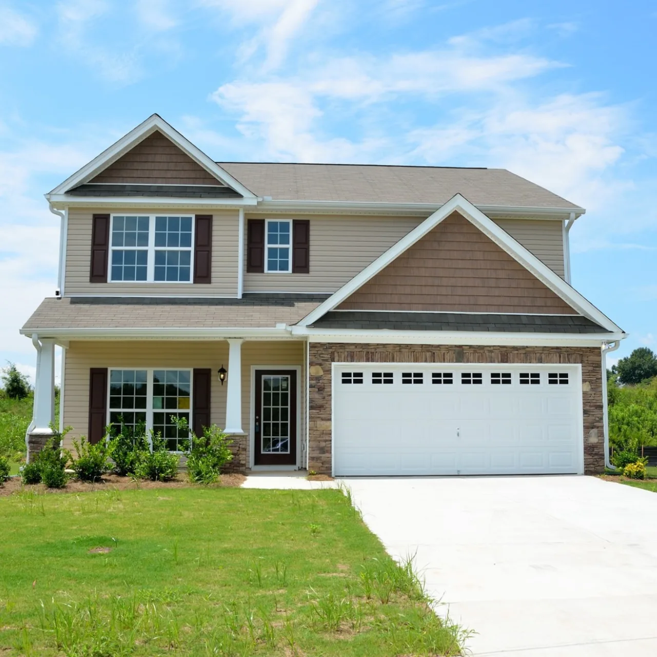 A two-story home with a newly installed two-car garage door