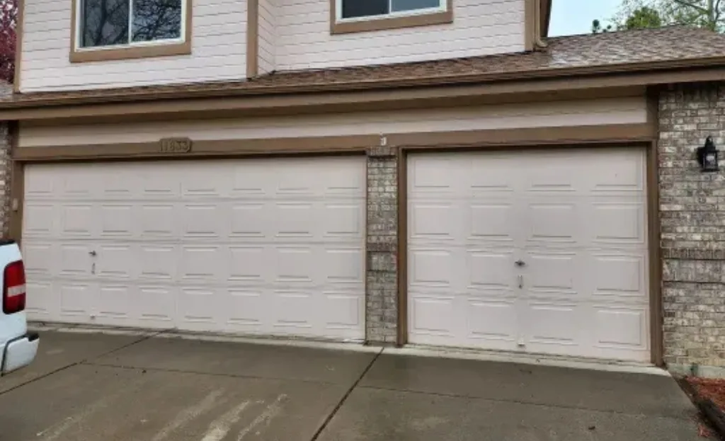 Two real white raised-panel garage doors G Brothers installed on a Denver-area home